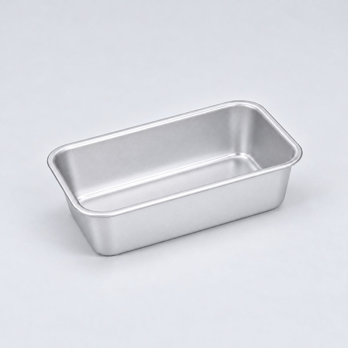 Empty silver aluminum loaf pan, 13.8 x 8 x 3.8 cm.