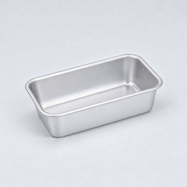 Empty silver aluminum loaf pan, 13.8 x 8 x 3.8 cm.