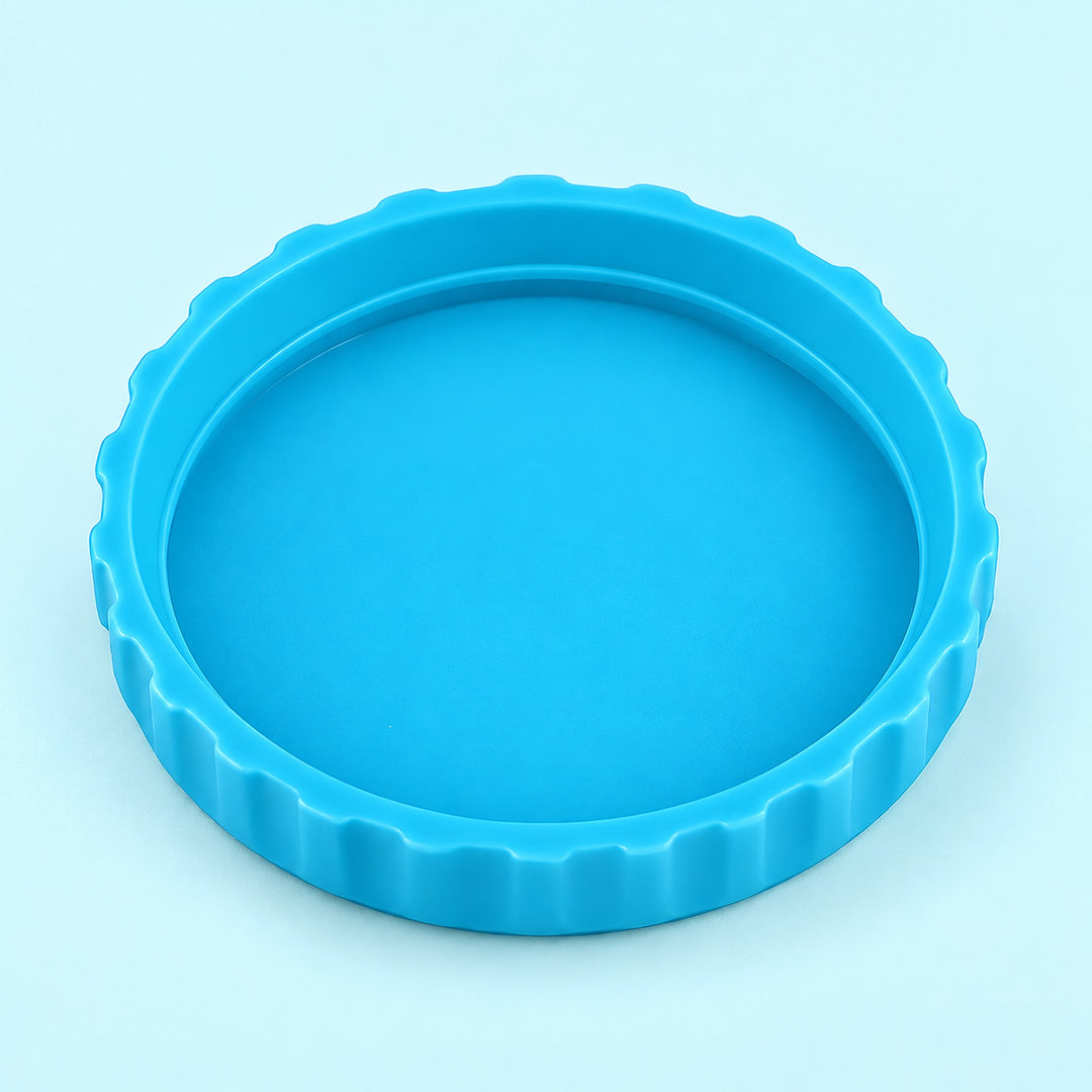 One cyan-blue lid, interior-up studio view on pale cyan.