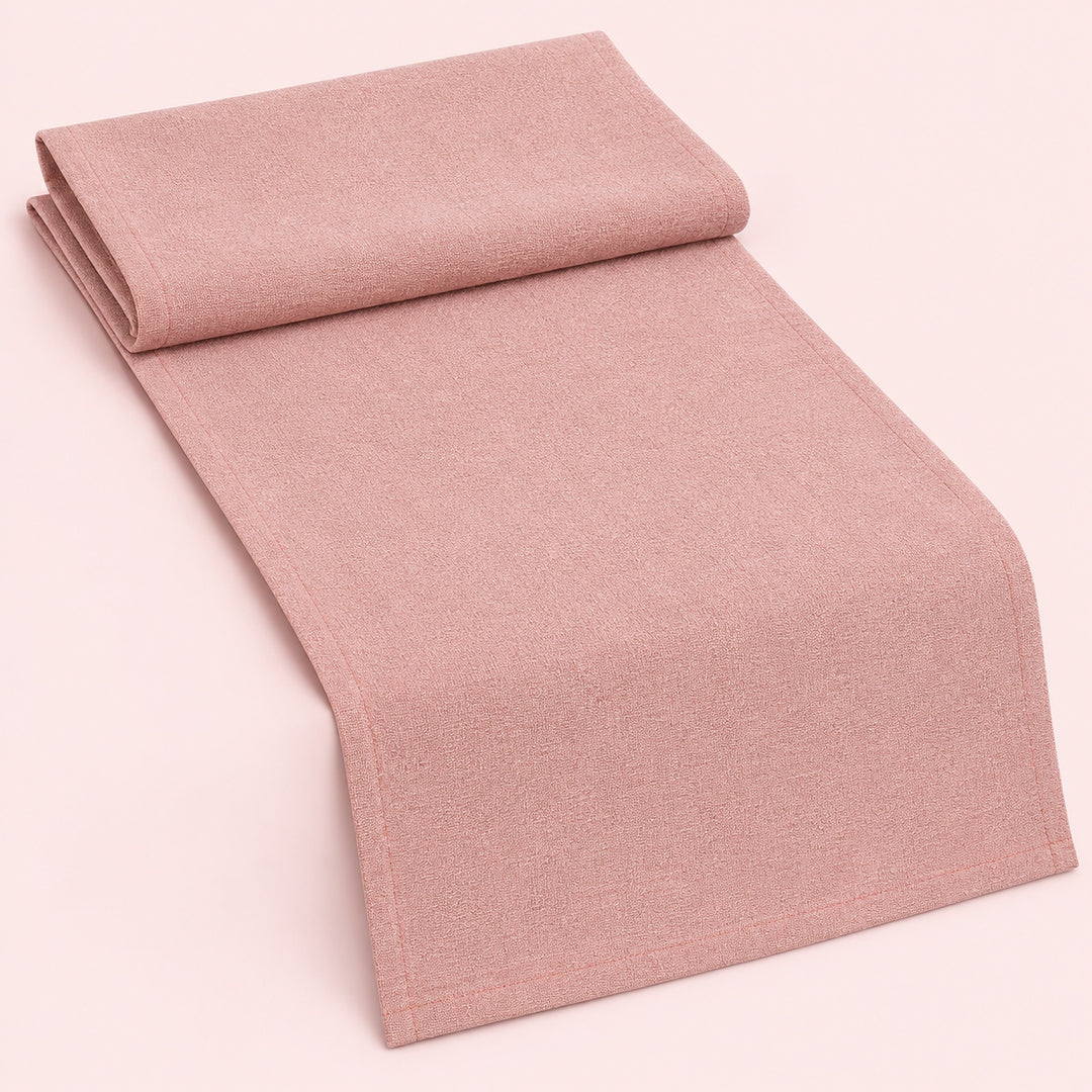 Pink cotton table runner with sewn edges, folded studio view; choose length separately.