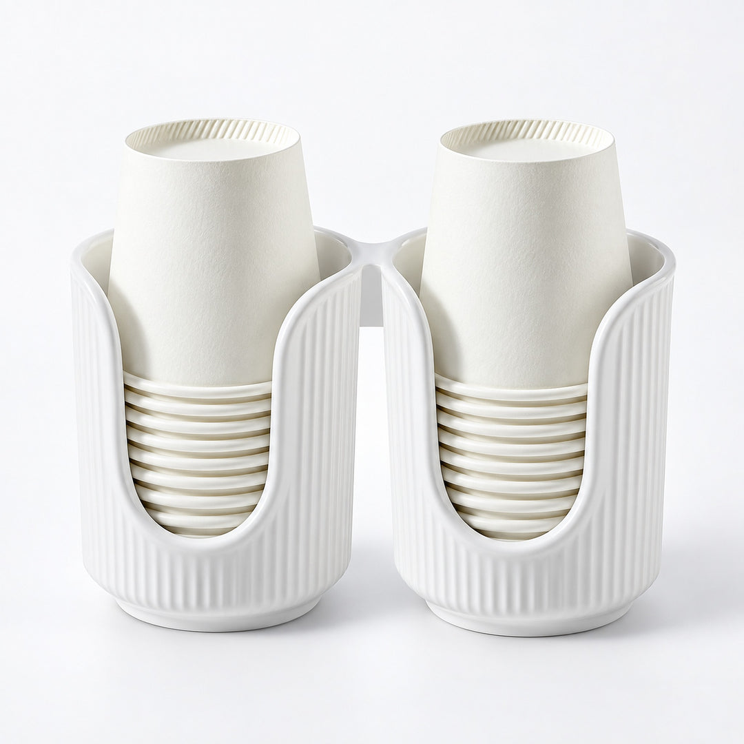 A white plastic dual-cup holder with two vertical compartments, each holding a stack of off-white paper cups, shown on a clean white background.