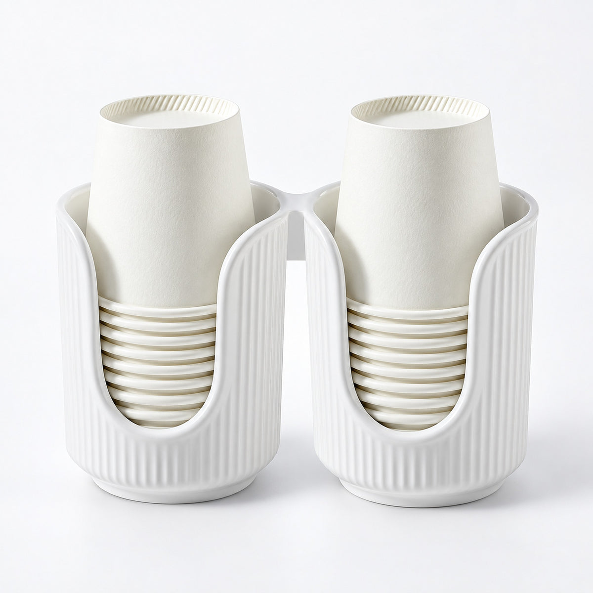 A white plastic dual-cup holder with two vertical compartments, each holding a stack of off-white paper cups, shown on a clean white background.