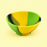 Yellow, green and black mini silicone bowl, single empty piece in studio.