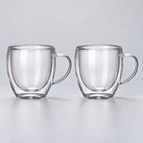 Two empty rounded 250 ml clear double-wall glass mugs with handles.