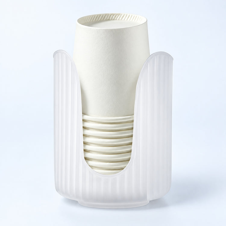 A stack of off-white paper cups held upright in a translucent white plastic cup holder with vertical ridges, photographed on a clean light blue studio background.