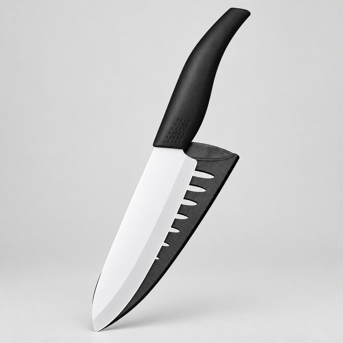 A kitchen knife with a black handle and a black sheath, featuring a silver blade with a distinctive finger guard cutout, shown against a light gray background.