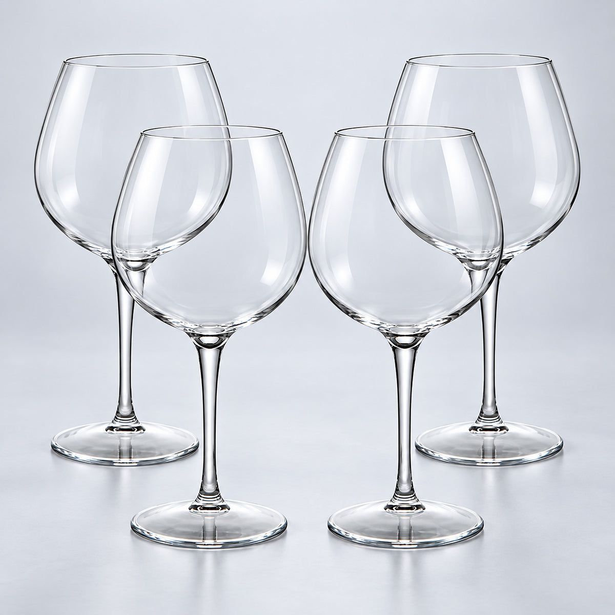 Burgundy set of 4: 4 empty clear stemmed Tritan wine cups on a pale gray studio background.