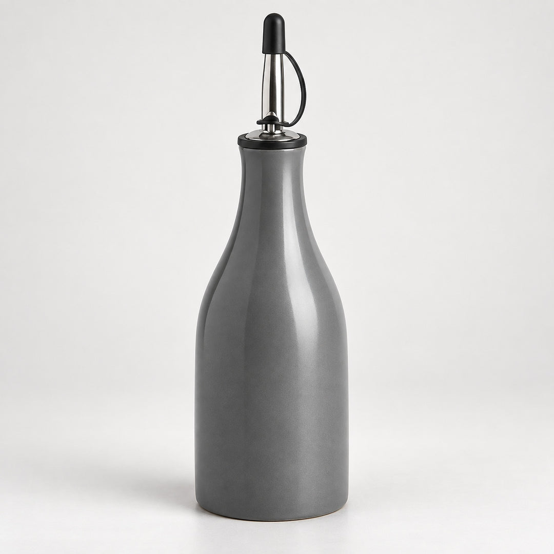 A matte gray ceramic bottle with a pour spout featuring a black plastic cap and a silver metal loop handle, set against a plain light gray background.