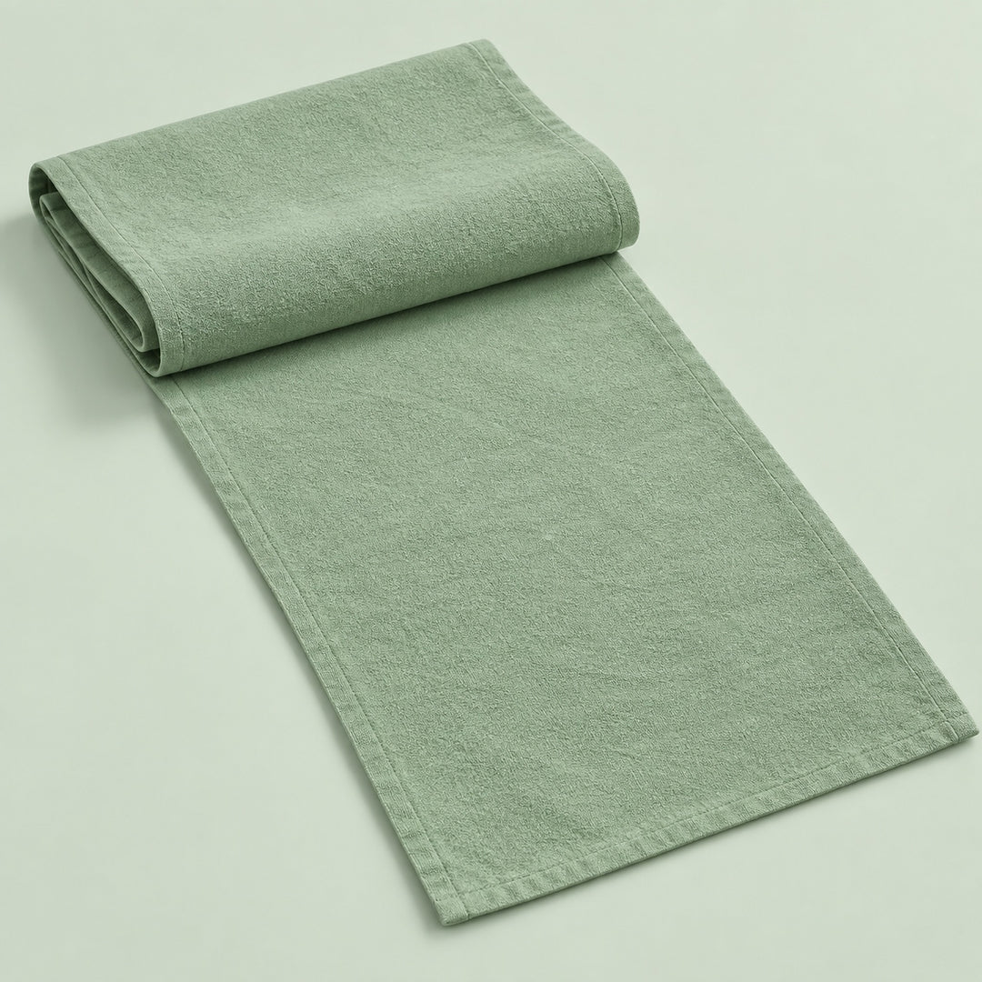 Light Green cotton table runner with sewn edges, folded studio view; choose length separately.