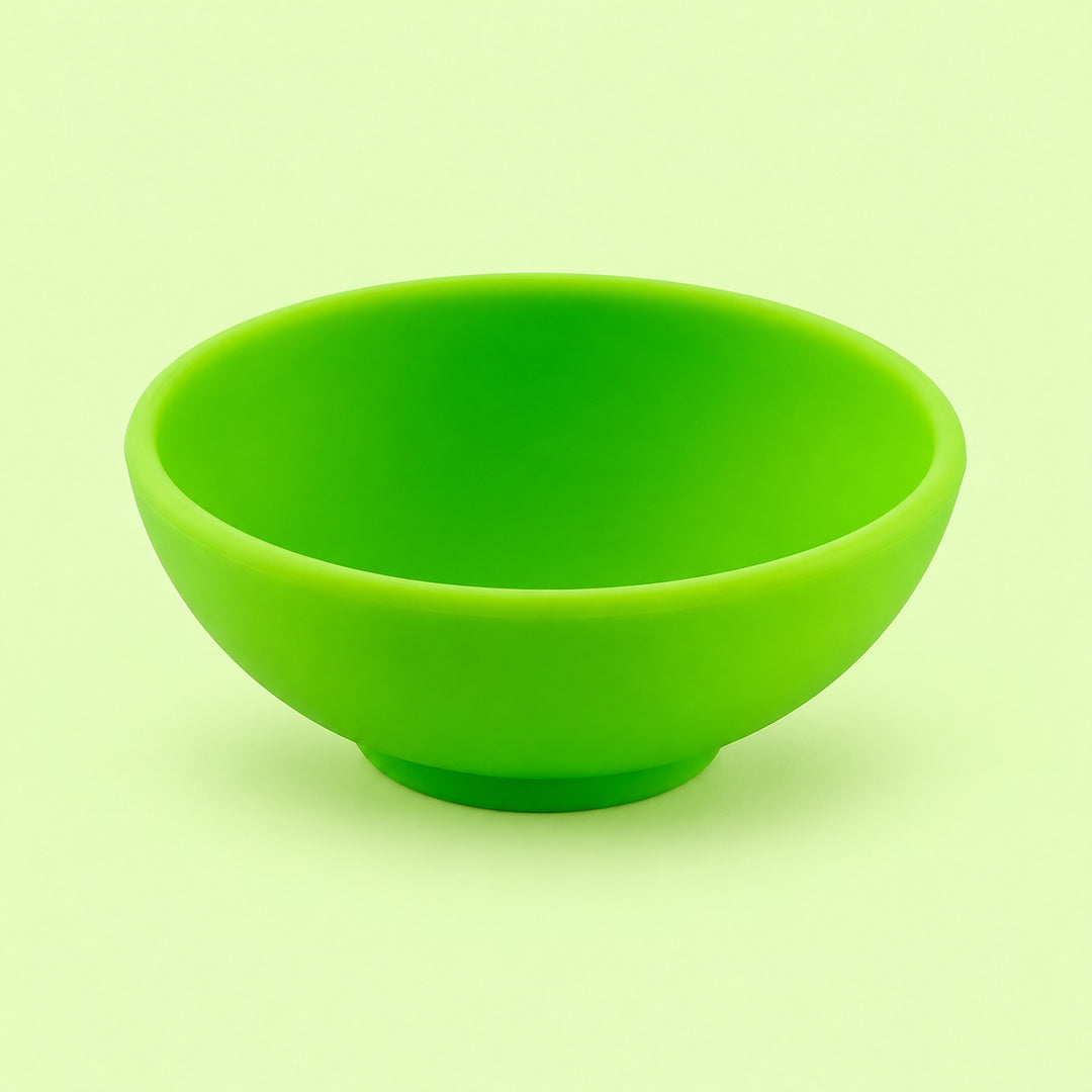 Lime-green mini silicone bowl, single empty piece in studio.