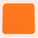 One orange square silicone coaster, 10 x 10 cm.