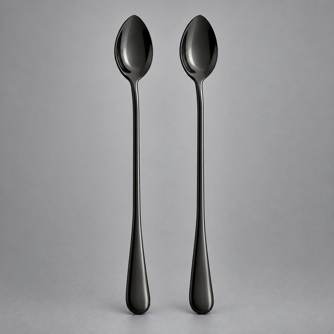 Two long-handled spoons with a glossy black finish, standing upright side-by-side against a neutral gray background.