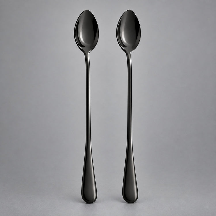Two long-handled spoons with a glossy black finish, standing upright side-by-side against a neutral gray background.