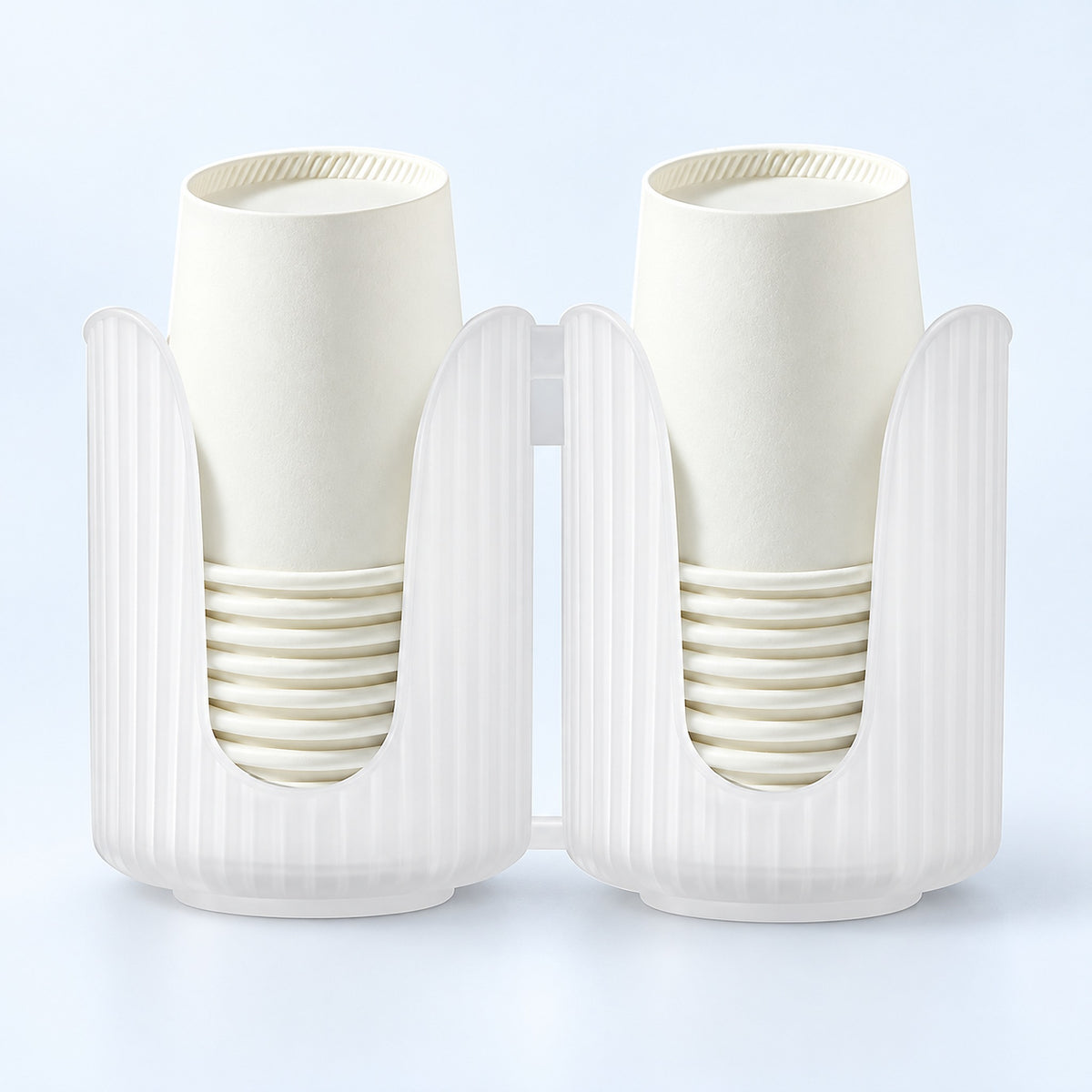 Two white paper cup holders with vertical fluting, each holding a stack of off-white paper cups, shown on a light blue studio background.