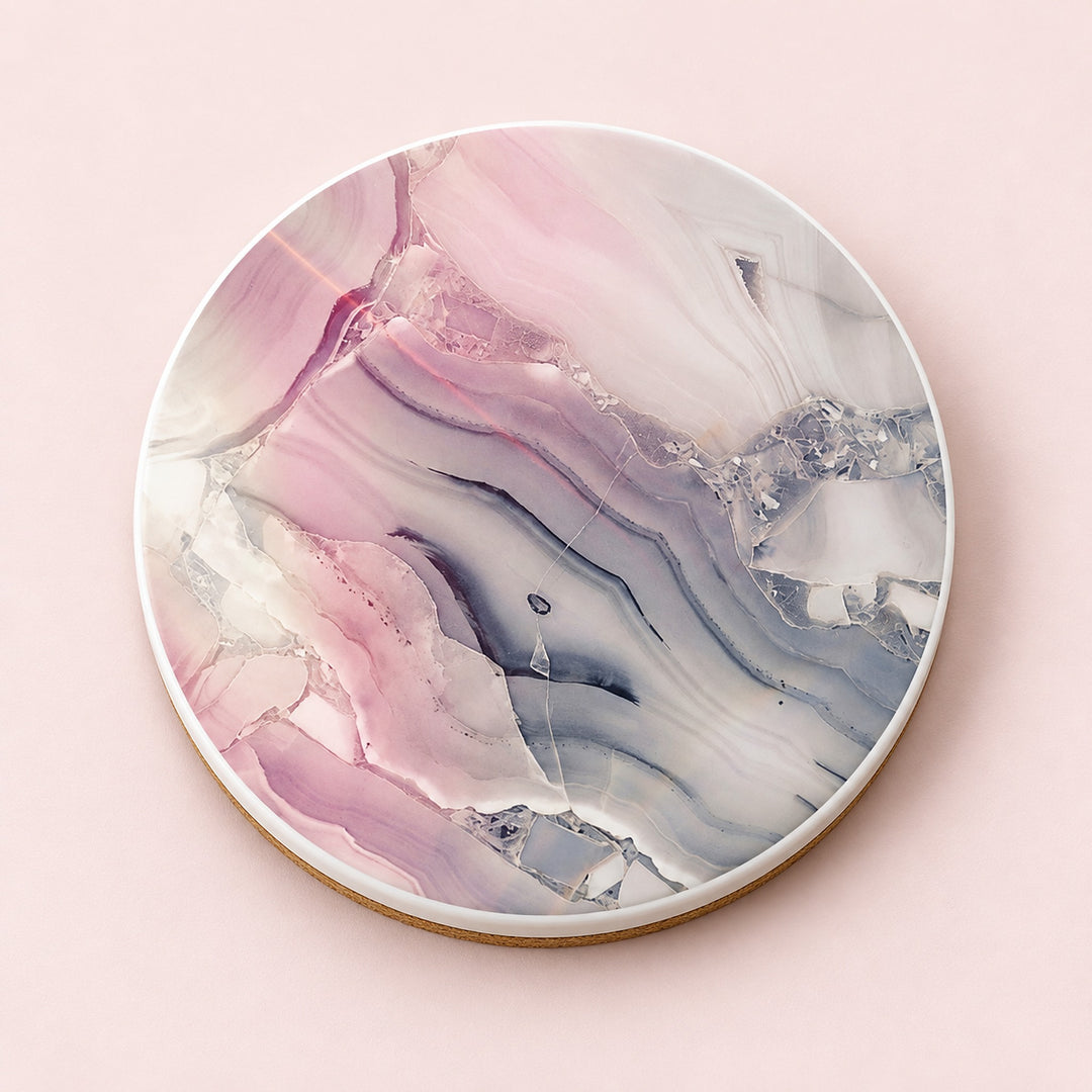 One blush pink and gray marble printed ceramic coaster on a light studio background.