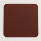 One brown square silicone coaster, 10 x 10 cm.