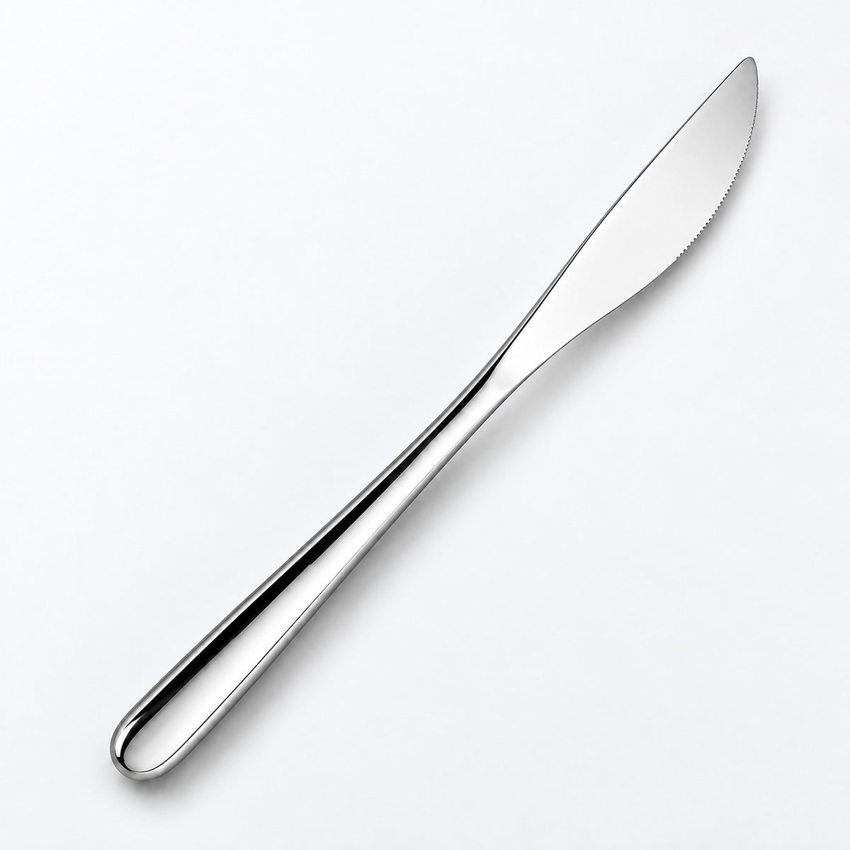 One silver dinner knife on a soft studio background.