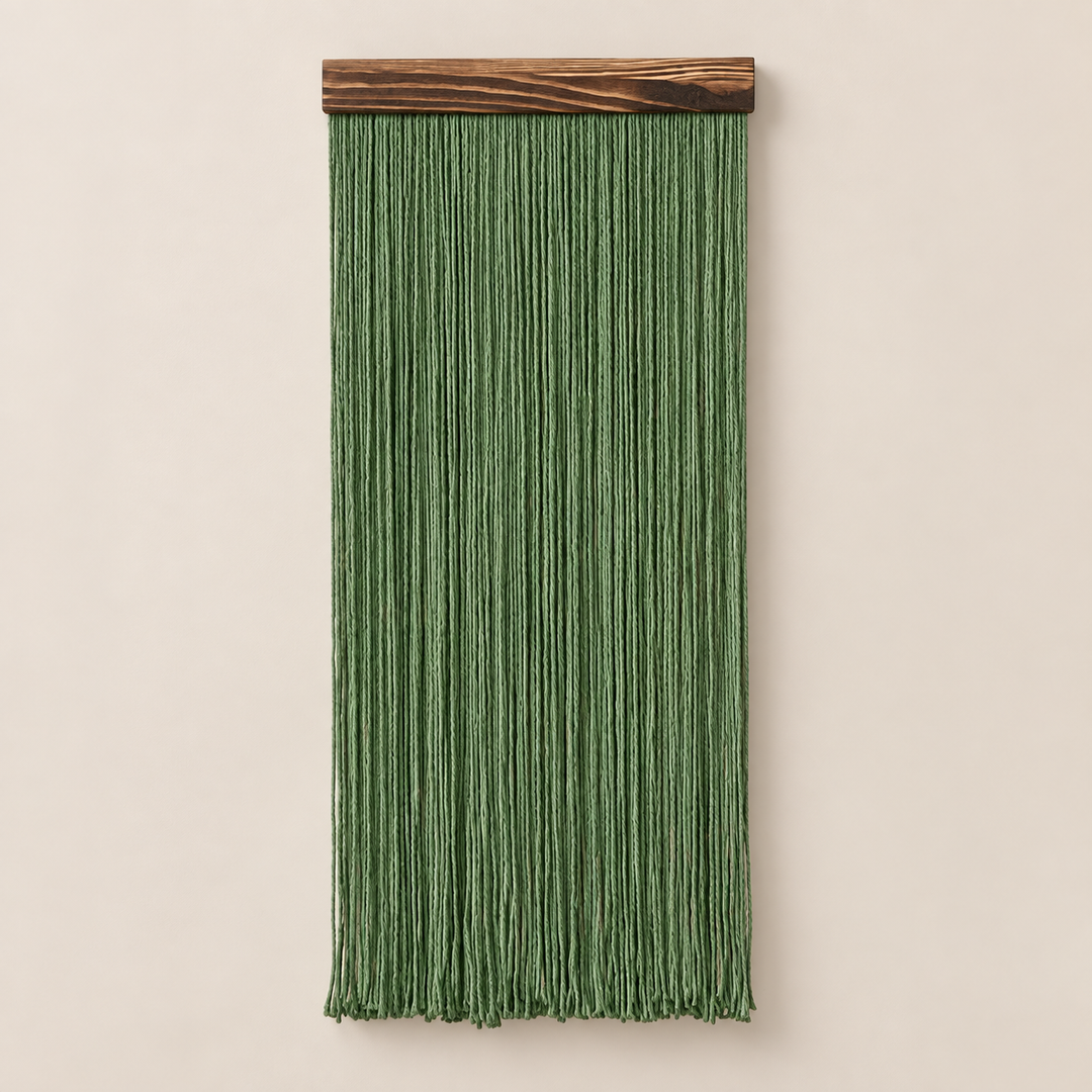 Forest green straight fringe panel hanging from a dark wood batten on cream
