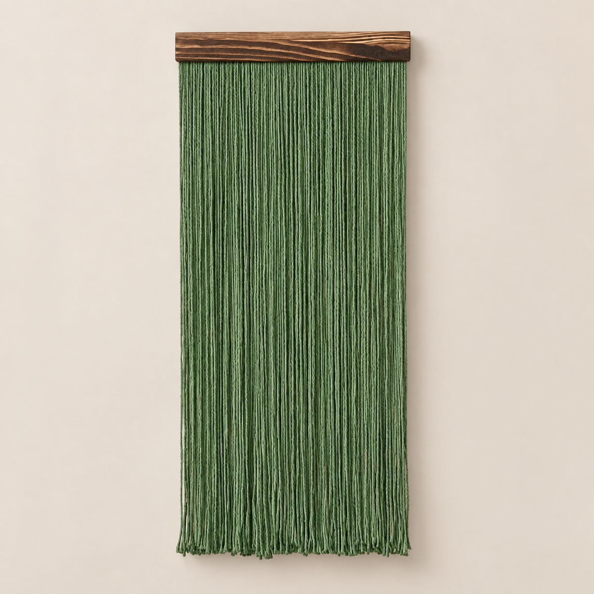 Forest green straight fringe panel hanging from a dark wood batten on cream