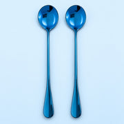 Two metallic blue spoons with long handles, arranged vertically side-by-side on a light blue background.