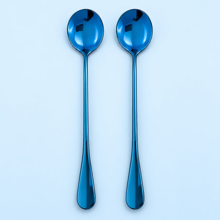 Two metallic blue spoons with long handles, arranged vertically side-by-side on a light blue background.