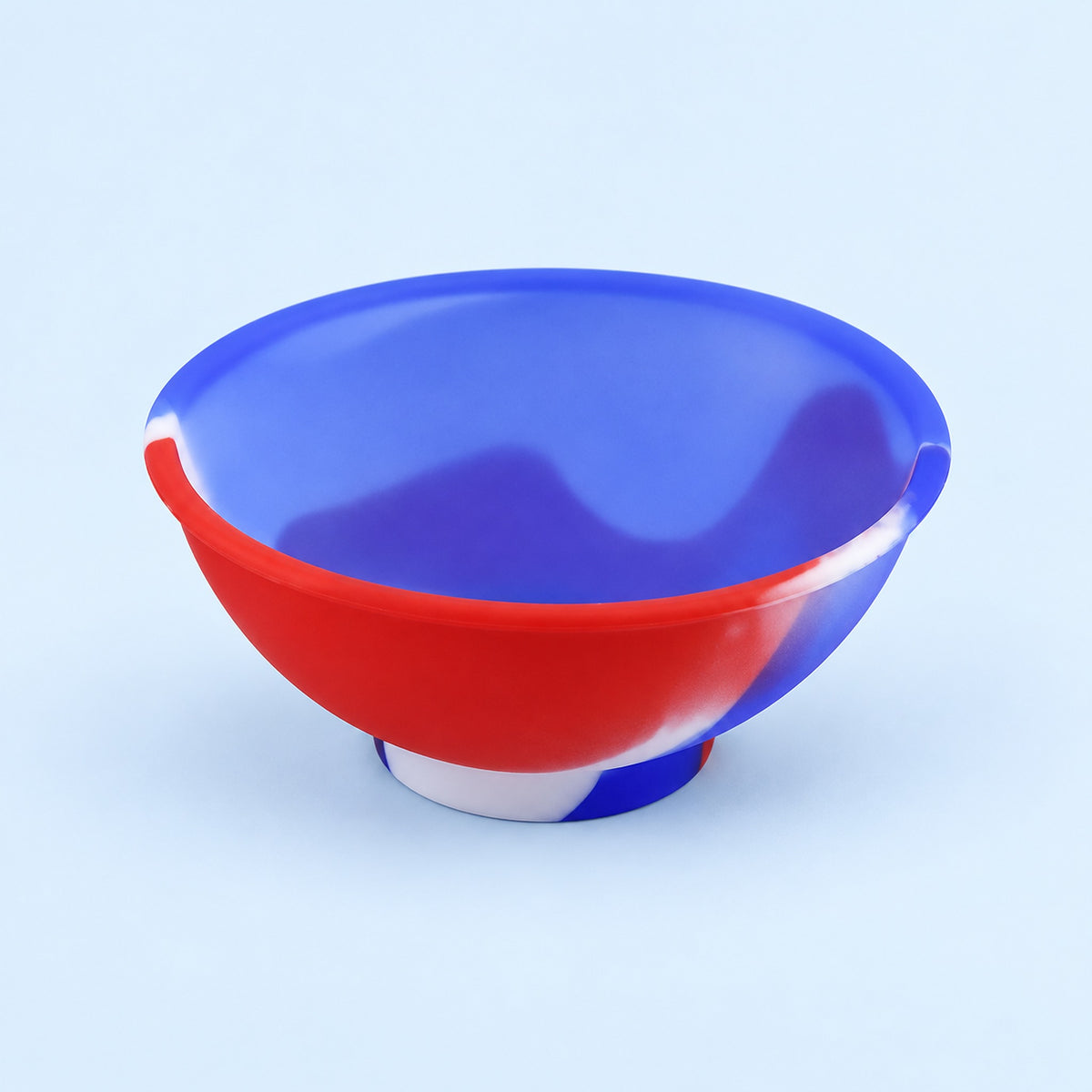Red, blue and white mini silicone bowl, single empty piece in studio.