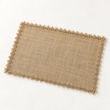 One tan placemat with tan looped trim, 30 x 45 cm.