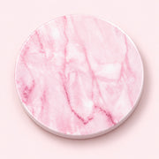 A round pink marble-patterned coaster with a white rim, shown from a top-down view on a solid pale pink background.