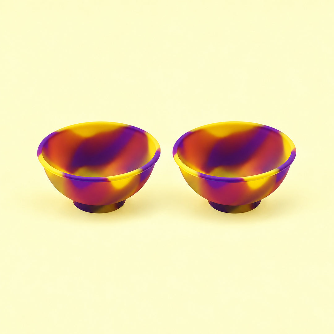 Two yellow and purple swirl silicone mini bowls, open tops and pedestal bases.