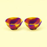 Two yellow and purple swirl silicone mini bowls, open tops and pedestal bases.