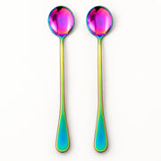 Two long spoons with iridescent rainbow-finish handles and oval bowls, shown upright on a plain white background.