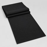Black cotton table runner with sewn edges, folded studio view; choose length separately.