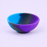 Blue, purple and black mini silicone bowl, single empty piece in studio.