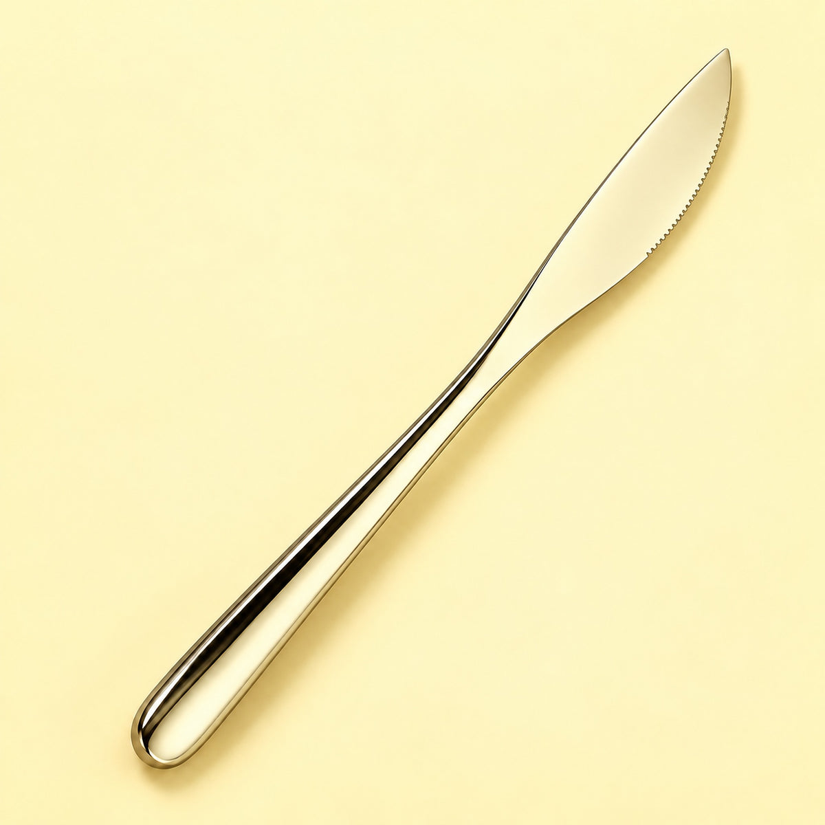 One champagne dinner knife on a soft studio background.