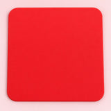 One red square silicone coaster, 10 x 10 cm.