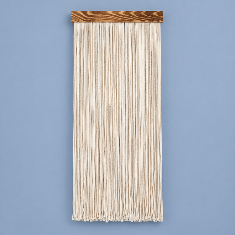 Cream straight fringe panel on a pale wooden batten against a blue background