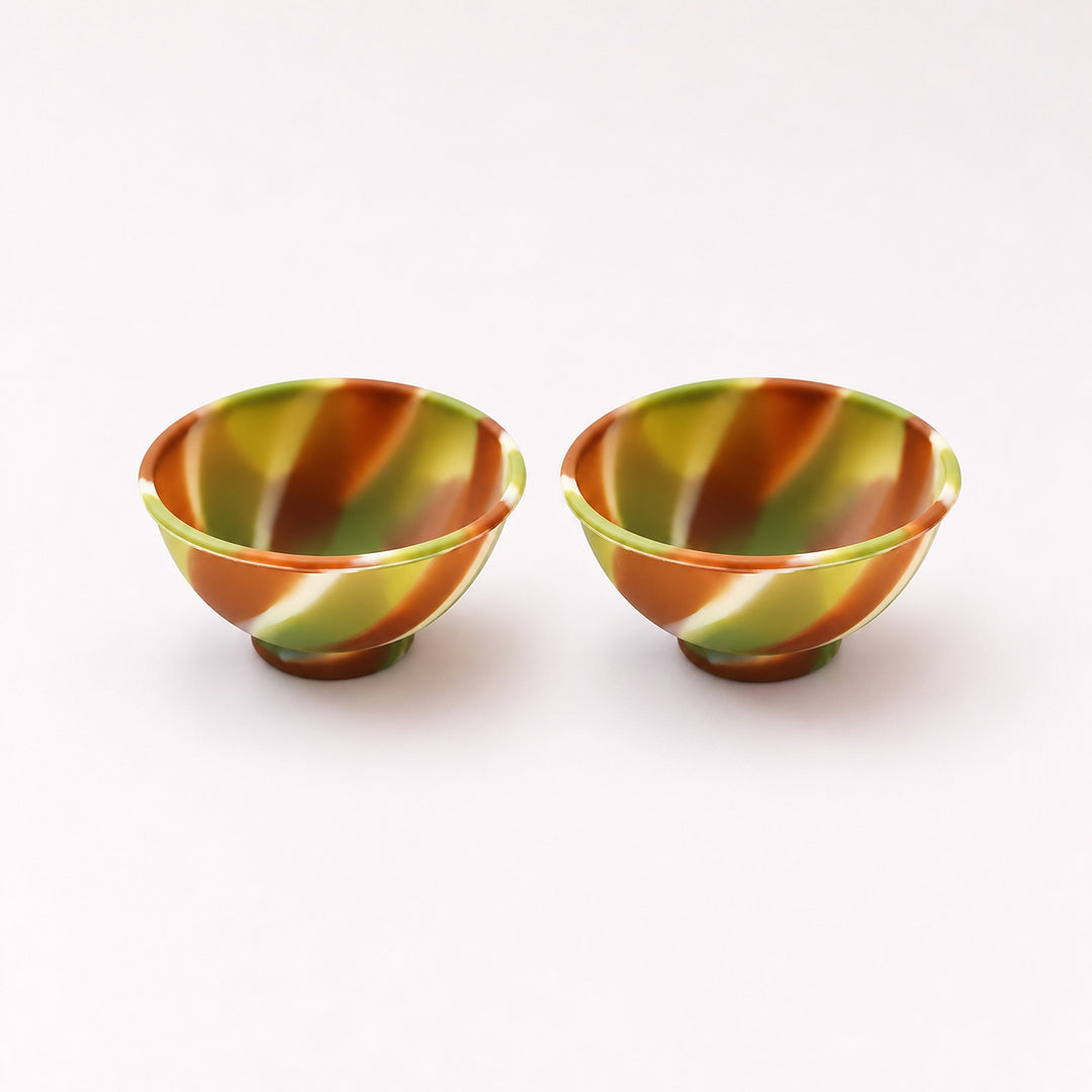 Two brown and cream swirl silicone mini bowls, open tops and pedestal bases.