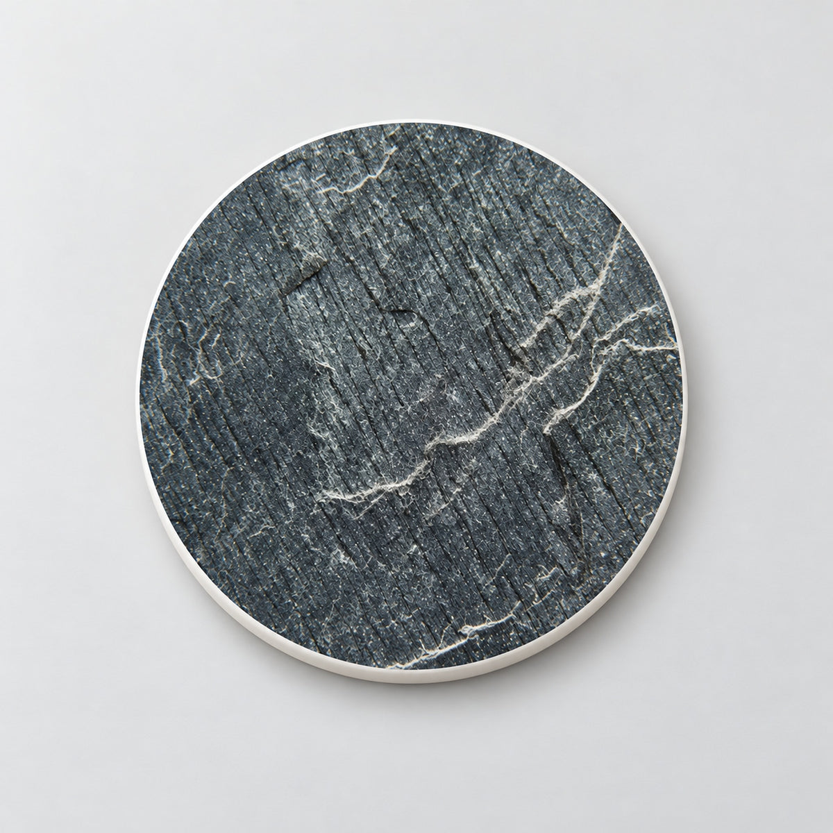 One charcoal fine vein marble printed ceramic coaster on a light studio background.