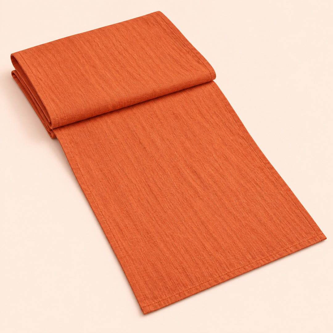 Orange Red cotton table runner with sewn edges, folded studio view; choose length separately.