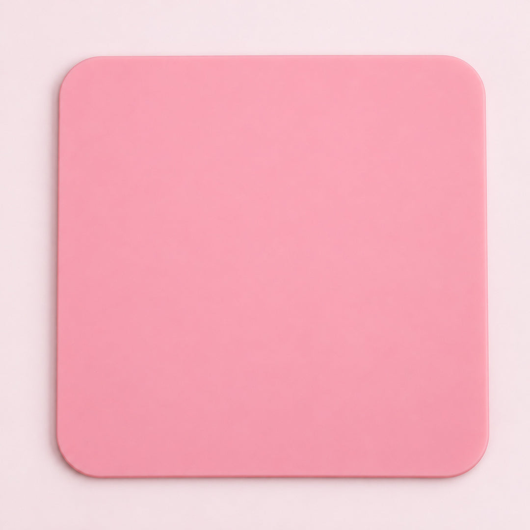 One pink square silicone coaster, 10 x 10 cm.