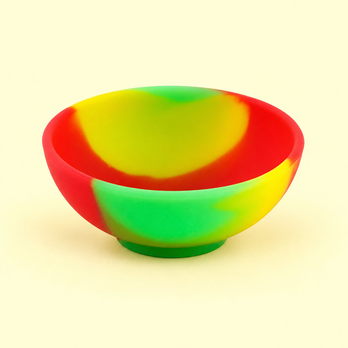 Red, yellow and green mini silicone bowl, single empty piece in studio.