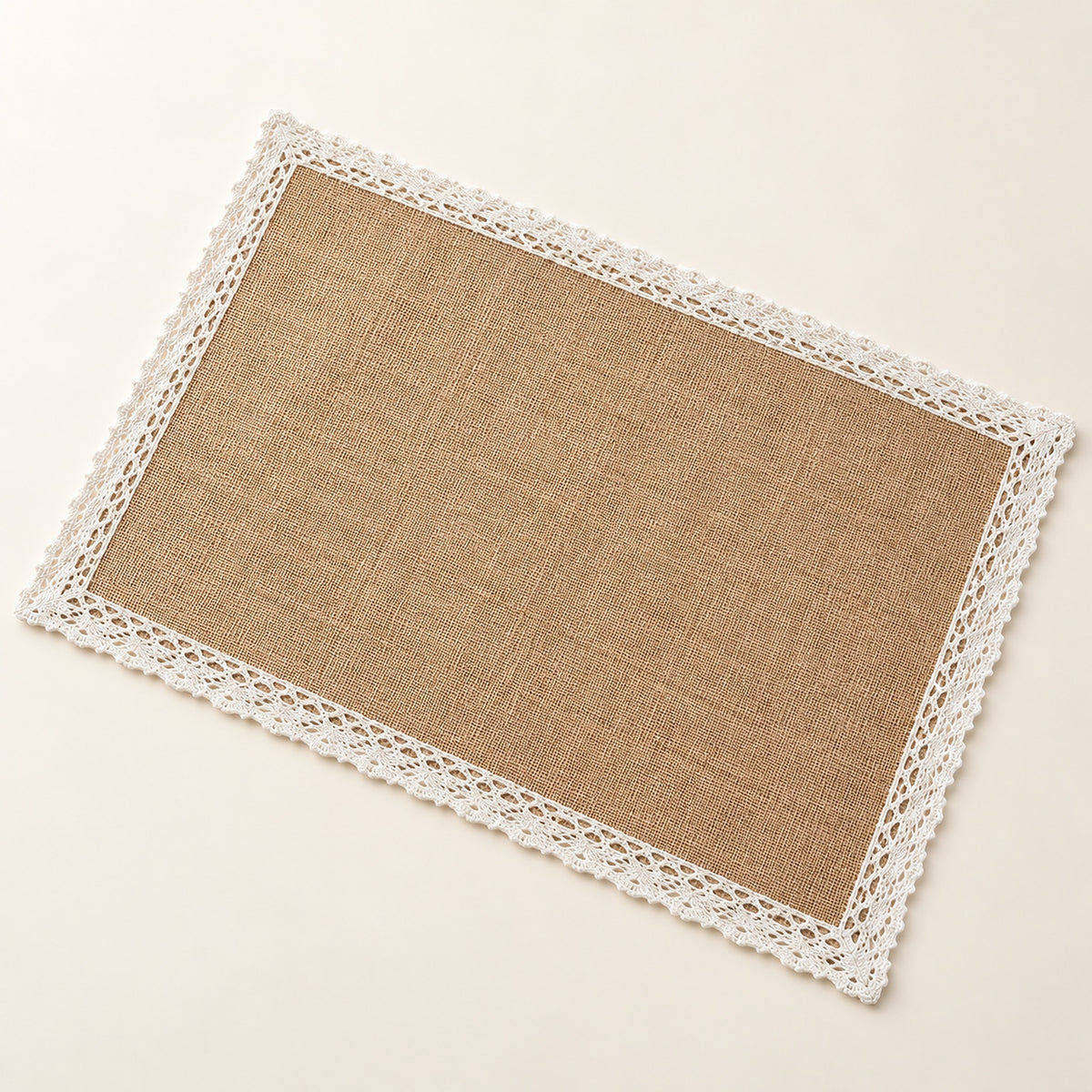 One tan placemat with white lace border trim, 30 x 45 cm.