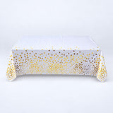 white with gold dots disposable plastic table cover style.