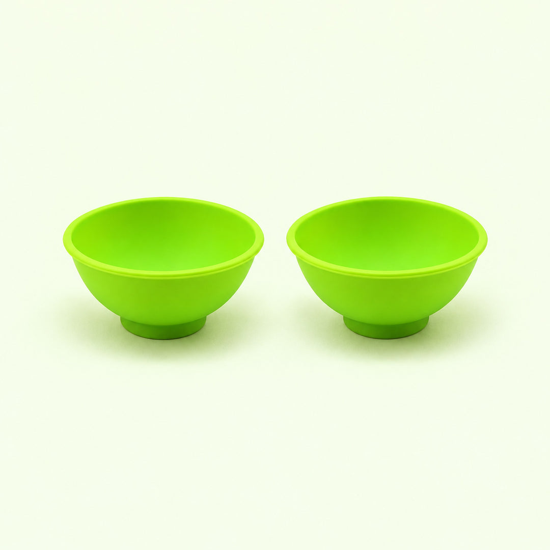 Two light green silicone mini bowls, open tops and pedestal bases.