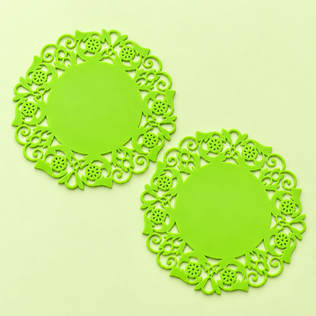 Two lime-green floral round silicone coasters, 9.5 cm diameter.