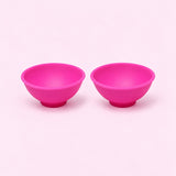 Two pink silicone mini bowls, open tops and pedestal bases.