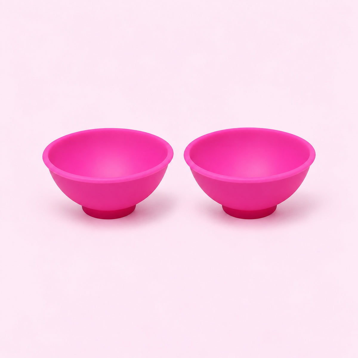 Two pink silicone mini bowls, open tops and pedestal bases.