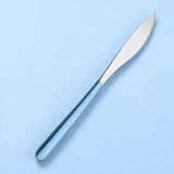 One sky blue and silver dinner knife on a soft studio background.