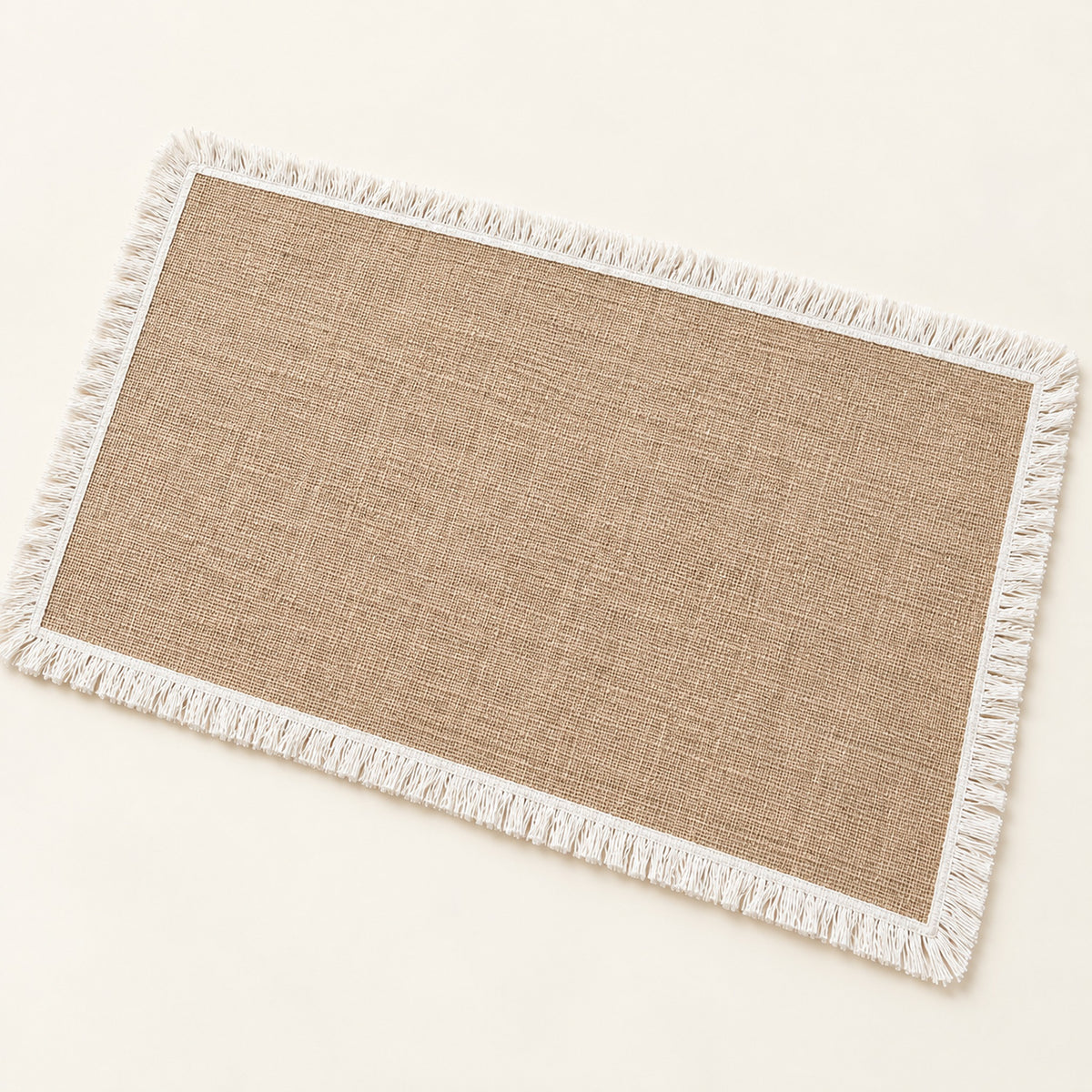 One tan placemat with white fringe trim, 30 x 45 cm.