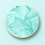 One aqua marble bands printed ceramic coaster on a light studio background.